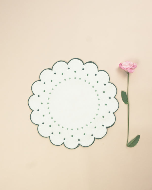 Flower shaped placemat with green embroidered borders and embroidered green dot details