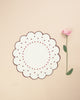 Flower shaped placemat in white with embroidered bordeaux borders and embroidered dot details